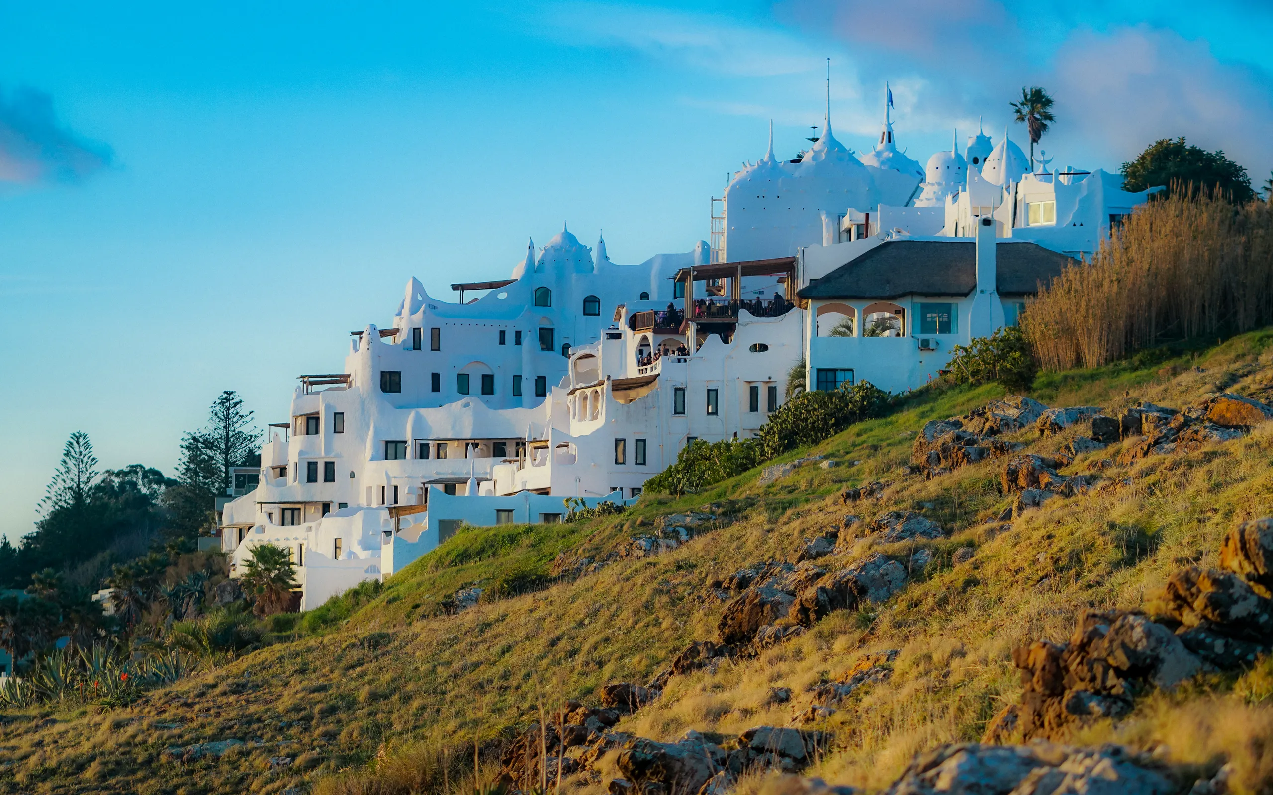 Casapueblo, Páez Vilaró's sculpted house on the Punta Ballena hillside, low sun lighting its white walls