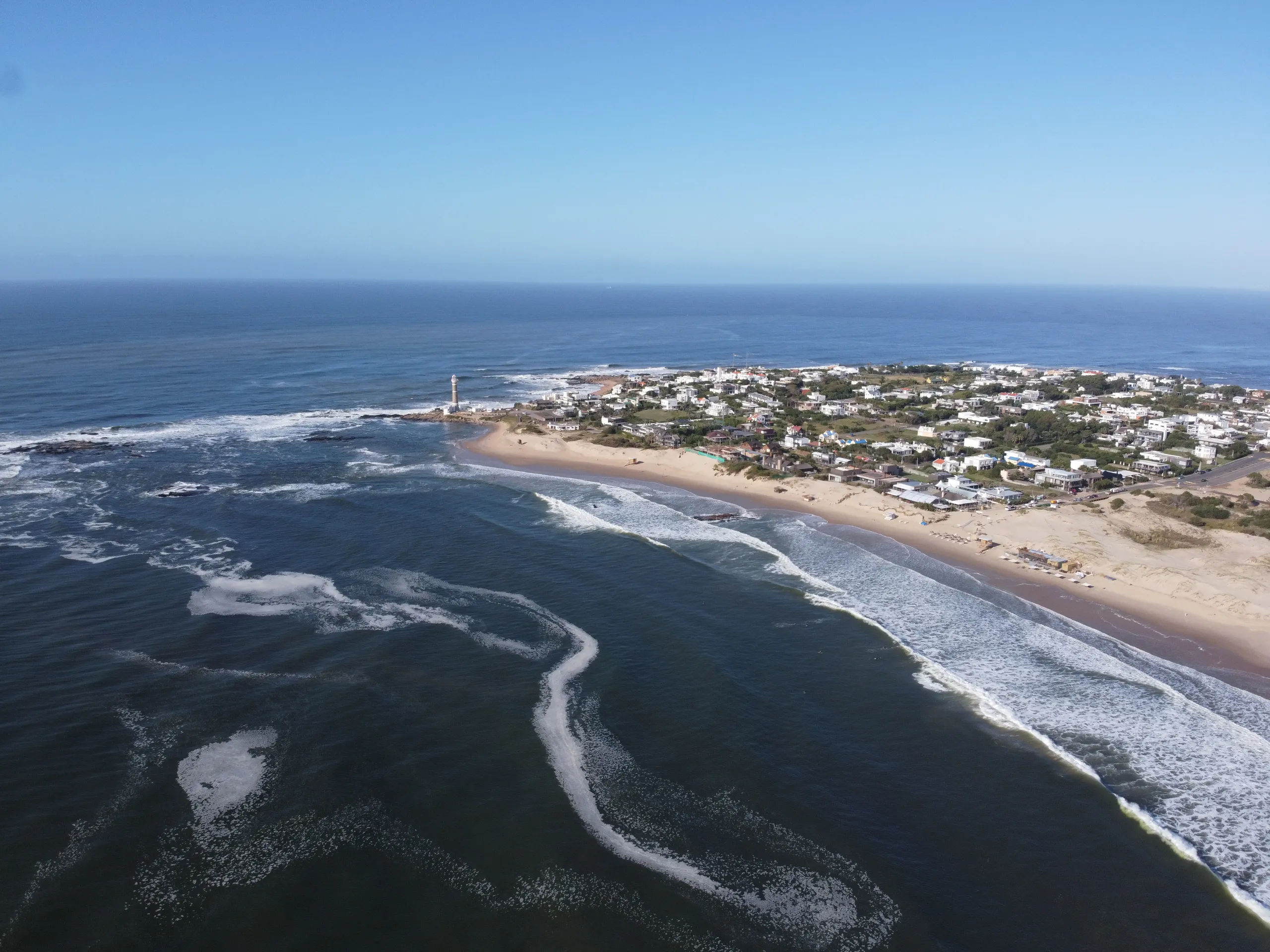 The José Ignacio coast from the air, waves breaking along the point