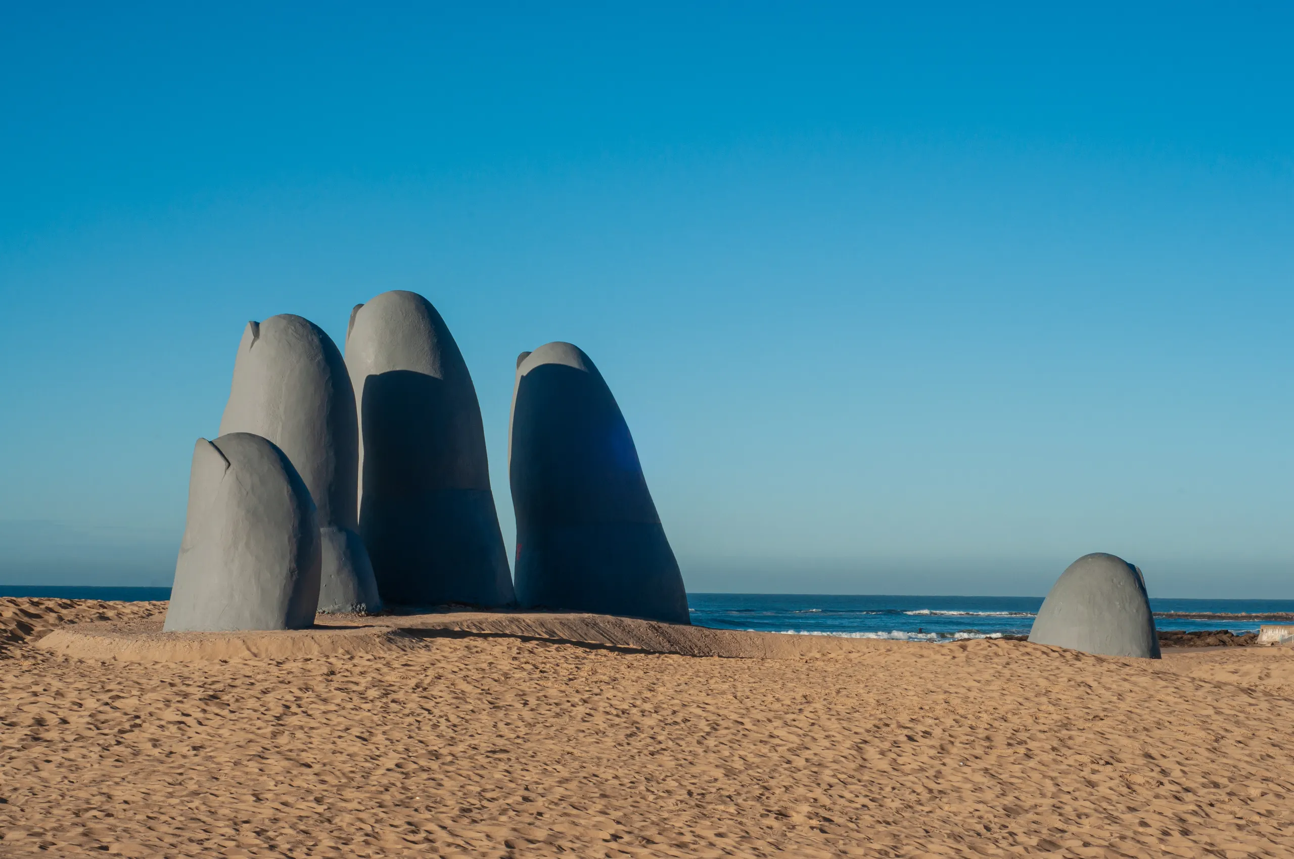 The La Mano sculpture rising out of the sand on Playa Brava